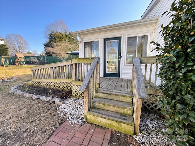 wooden deck featuring a playground