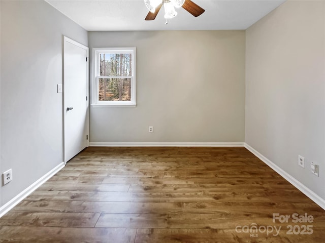 unfurnished room with hardwood / wood-style flooring and ceiling fan