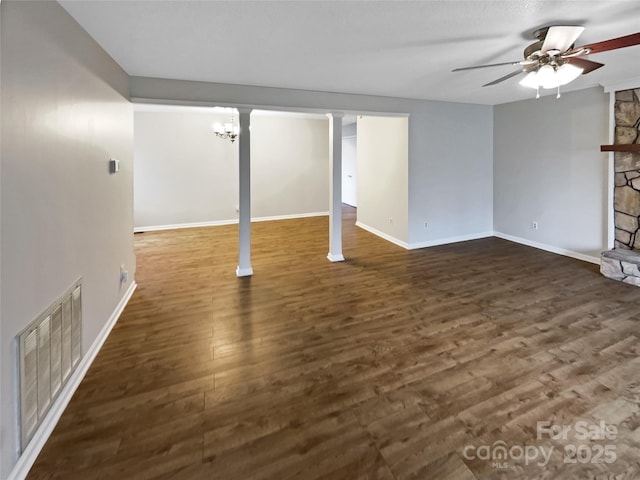 unfurnished living room with dark wood-type flooring, a fireplace, and ceiling fan