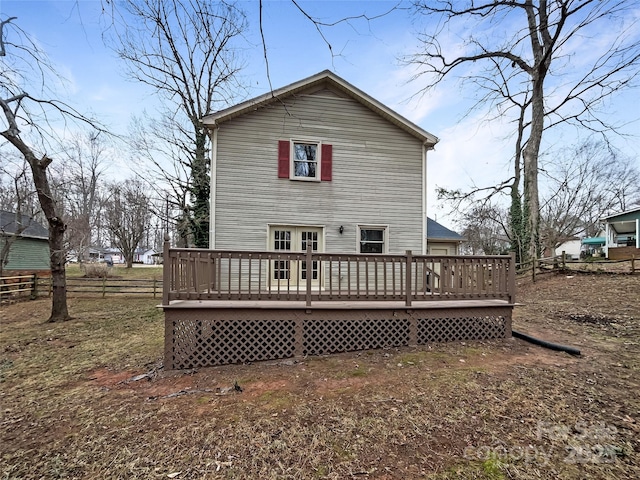 back of property featuring a wooden deck and french doors