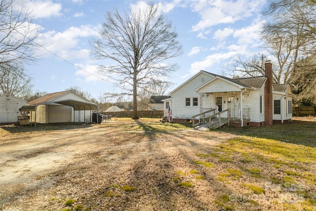 exterior space featuring a carport and a yard