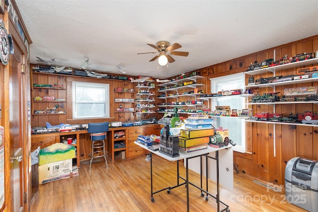 office space featuring ceiling fan, a textured ceiling, and light wood-type flooring