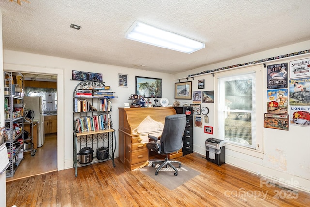 office space featuring hardwood / wood-style floors and a textured ceiling