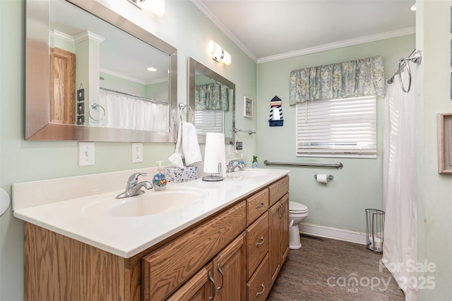 bathroom featuring ornamental molding, vanity, and toilet