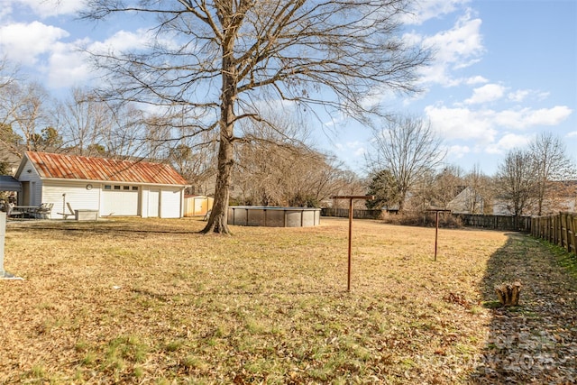 view of yard with a fenced in pool and an outbuilding