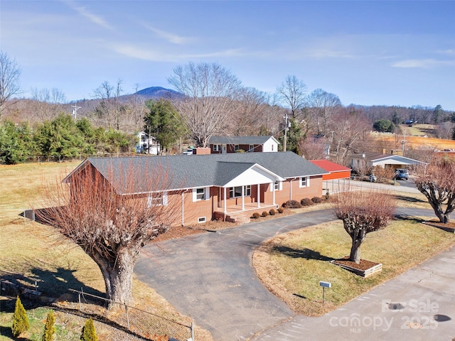 ranch-style house with a mountain view and a porch