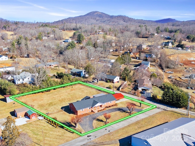 birds eye view of property with a mountain view