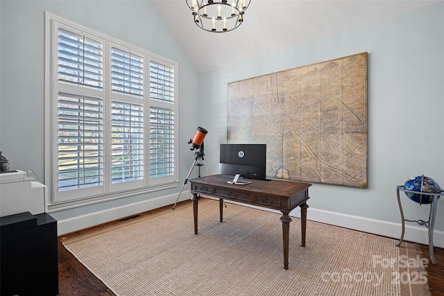 office space featuring hardwood / wood-style flooring, lofted ceiling, and an inviting chandelier