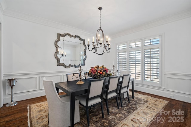 dining area with crown molding, an inviting chandelier, and dark wood-type flooring