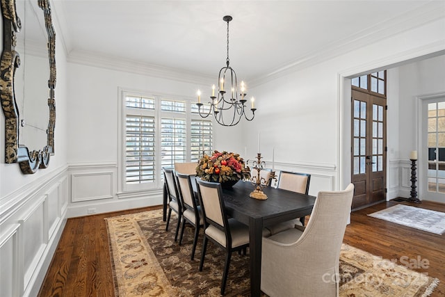 dining room featuring ornamental molding, dark hardwood / wood-style flooring, and a chandelier