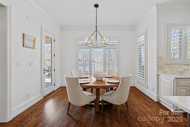 dining area featuring dark wood-type flooring, crown molding, and an inviting chandelier