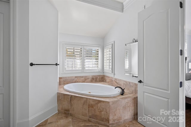 bathroom featuring lofted ceiling, ornamental molding, and tiled bath