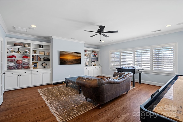 living room featuring dark wood-type flooring, ceiling fan, and ornamental molding