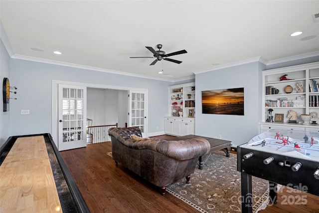 living room featuring french doors, ornamental molding, dark hardwood / wood-style floors, built in features, and ceiling fan