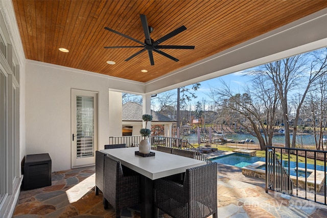 view of patio / terrace featuring a water view and ceiling fan