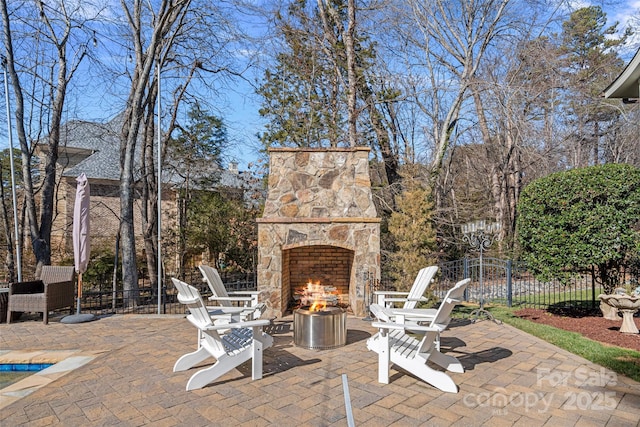 view of patio / terrace featuring an outdoor stone fireplace