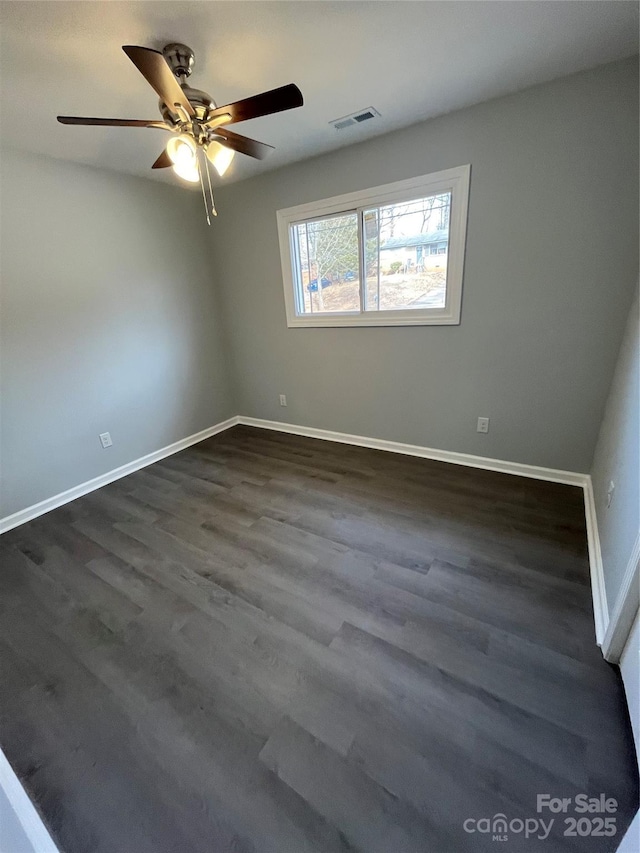 unfurnished room with dark hardwood / wood-style floors and ceiling fan