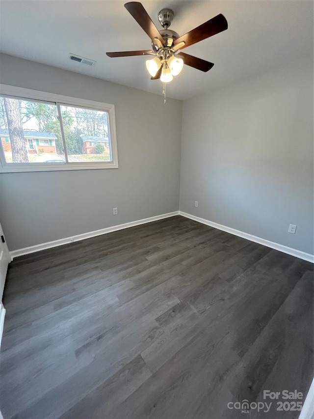 spare room with dark hardwood / wood-style floors