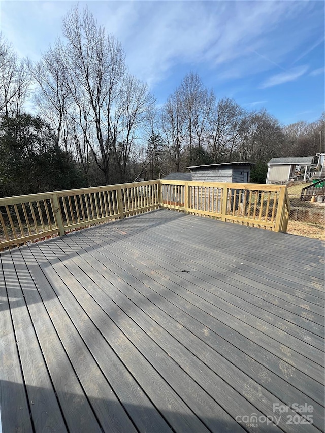 wooden deck featuring a shed