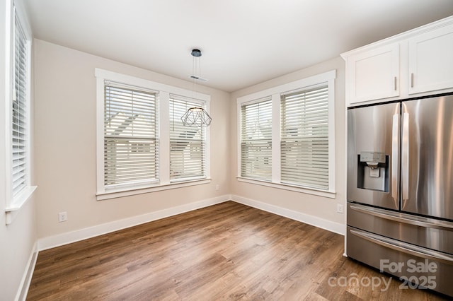 unfurnished dining area featuring hardwood / wood-style flooring