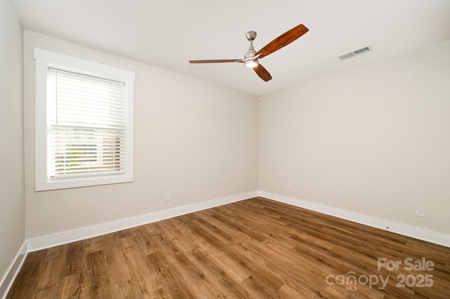 spare room with wood-type flooring and ceiling fan