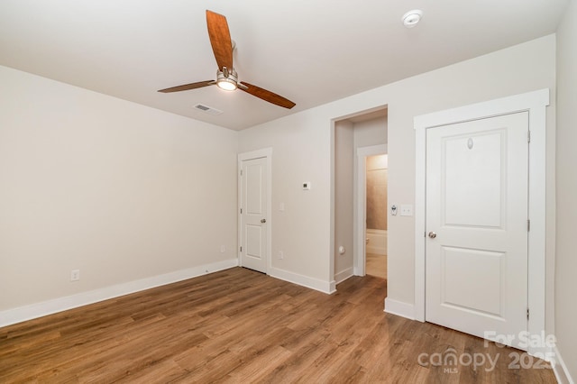 unfurnished bedroom with hardwood / wood-style floors and ceiling fan