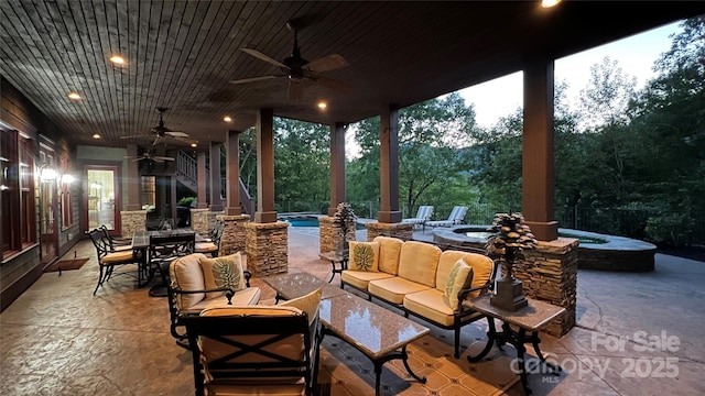 view of patio / terrace with ceiling fan, a pool with connected hot tub, outdoor dining area, and an outdoor living space