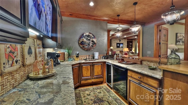 kitchen with hanging light fixtures, backsplash, brown cabinetry, light stone countertops, and beverage cooler