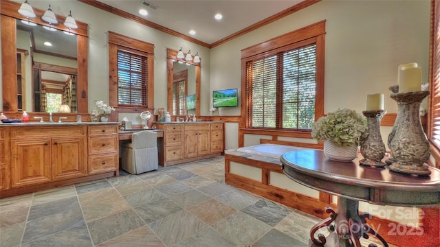 full bathroom featuring stone tile floors, visible vents, a garden tub, crown molding, and a sink