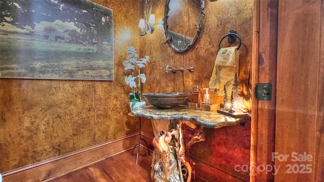 bathroom featuring a sink and wood finished floors