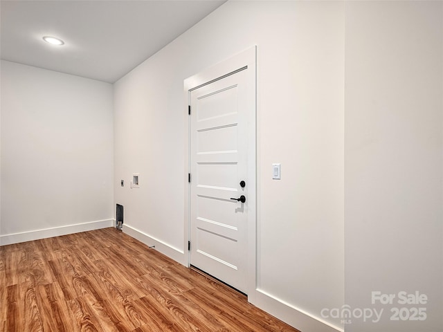 washroom with hookup for a washing machine, electric dryer hookup, and light hardwood / wood-style floors