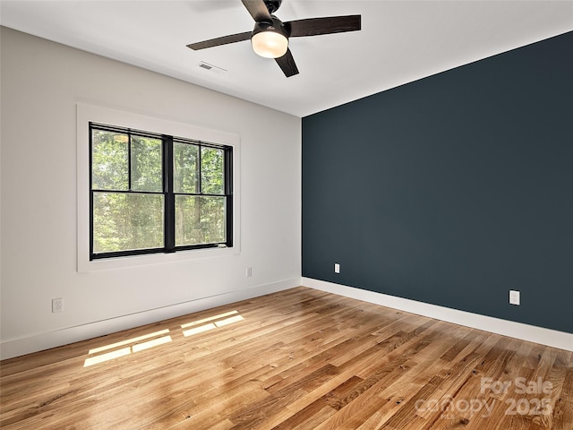 spare room featuring ceiling fan and light wood-type flooring