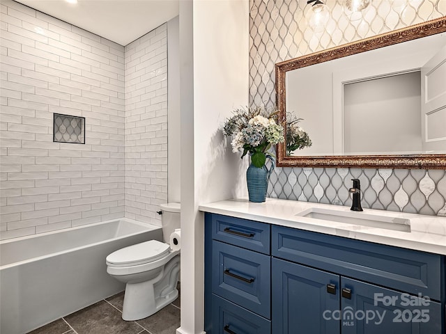 full bathroom featuring tiled shower / bath combo, vanity, tasteful backsplash, and toilet