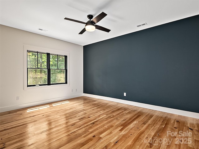 empty room featuring ceiling fan and light wood-type flooring