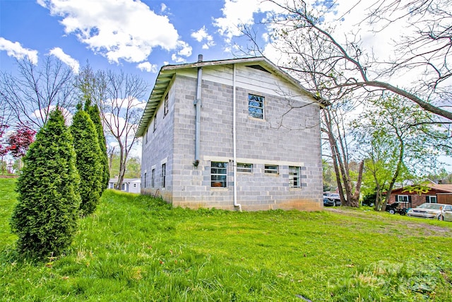 rear view of house featuring a lawn