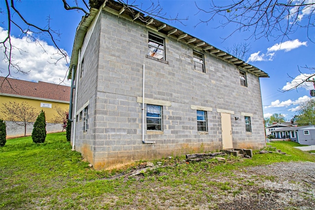 back of property featuring a lawn