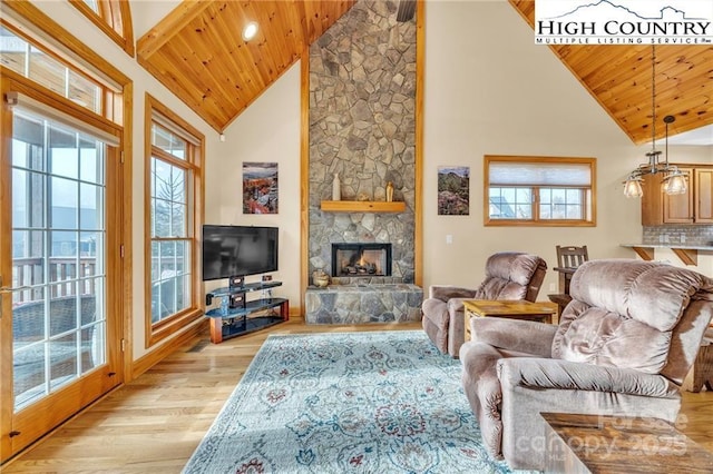 living room with a wealth of natural light, wooden ceiling, and light hardwood / wood-style floors