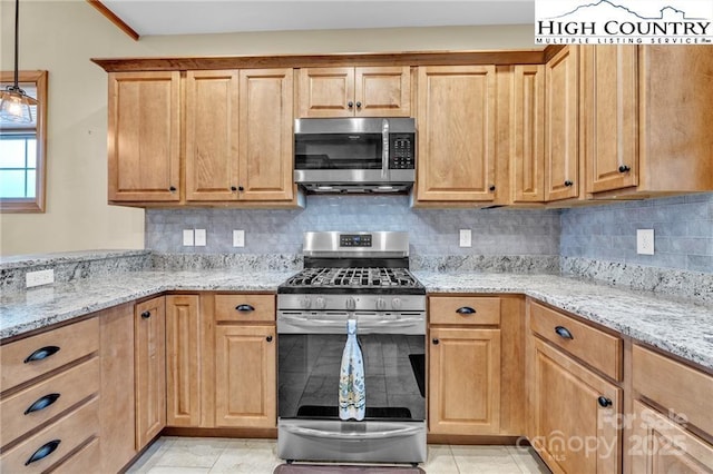 kitchen featuring decorative backsplash, stainless steel appliances, light stone countertops, and hanging light fixtures