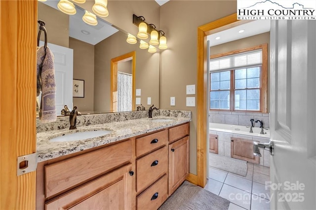 bathroom featuring a relaxing tiled tub, tile patterned floors, and vanity