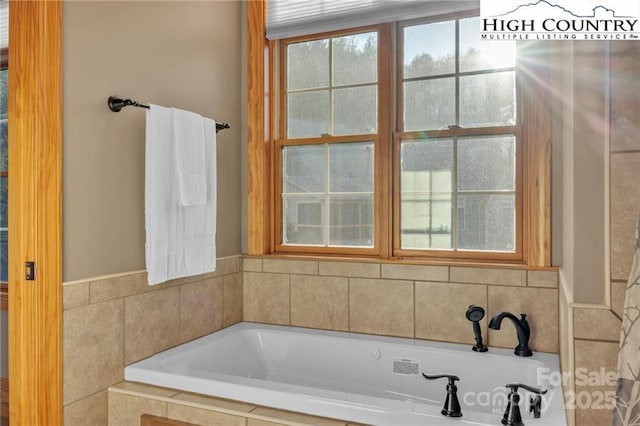 bathroom featuring tiled tub