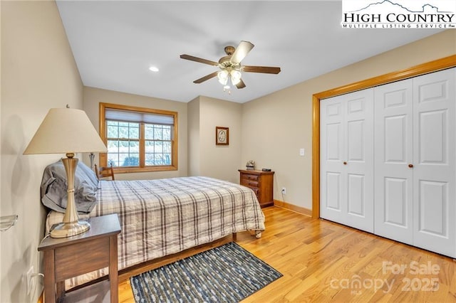 bedroom with a closet, ceiling fan, and light hardwood / wood-style flooring