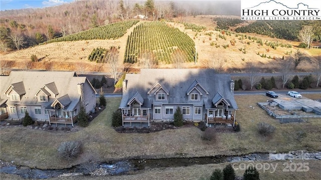 birds eye view of property with a rural view