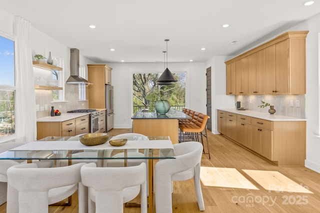 dining room with light wood-type flooring, baseboards, and recessed lighting