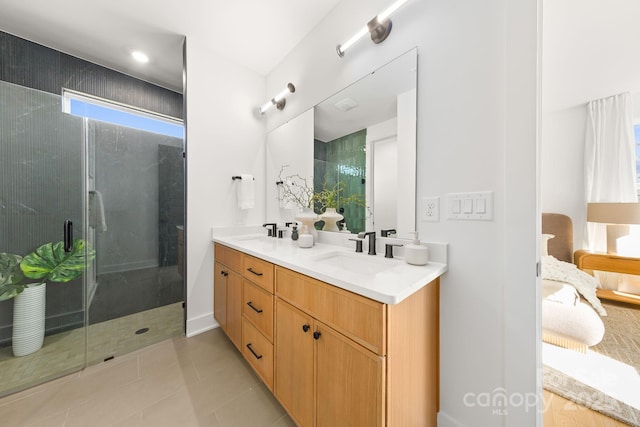 bathroom featuring a sink, a shower stall, and double vanity