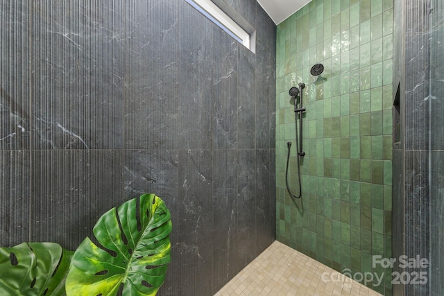 bathroom with a tile shower