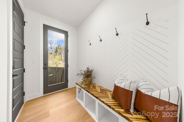 mudroom featuring light wood-type flooring and baseboards