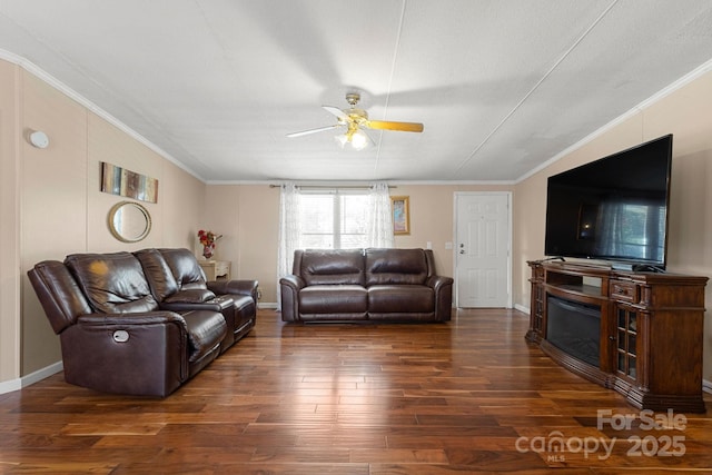 living room with crown molding, ceiling fan, and dark hardwood / wood-style flooring