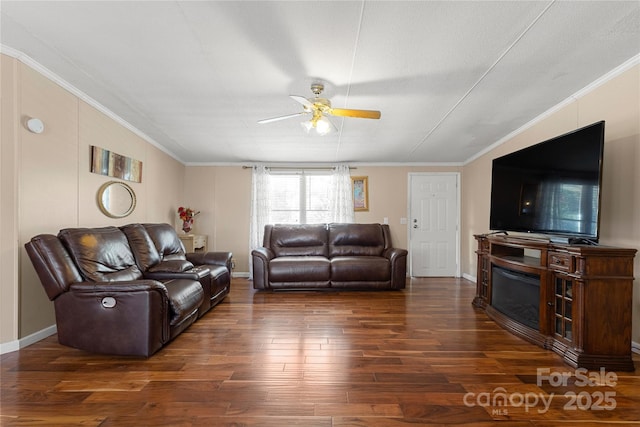 living room with ornamental molding, dark hardwood / wood-style floors, and ceiling fan