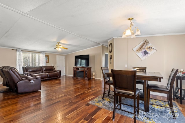 dining room with hardwood / wood-style flooring, ceiling fan with notable chandelier, and ornamental molding