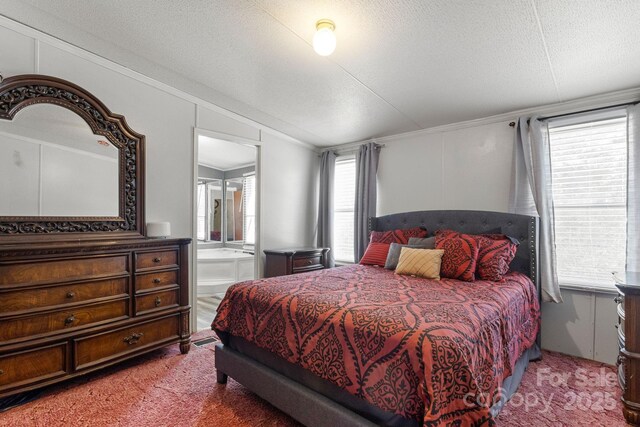 bedroom with multiple windows, carpet flooring, and a textured ceiling